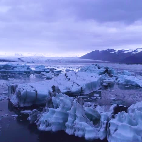 drone aerial over icebergs in a glacial bay suggest global warming in the arctic at jokulsarlon glacier lagoon iceland night