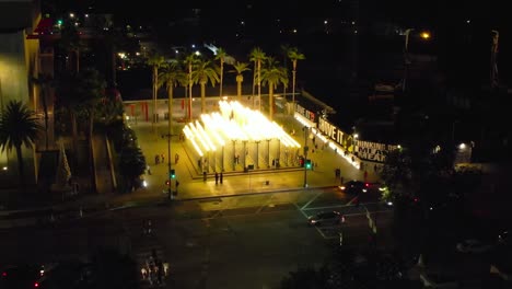 aerial ascending view of urban light installation in the los angeles county museum of art at night