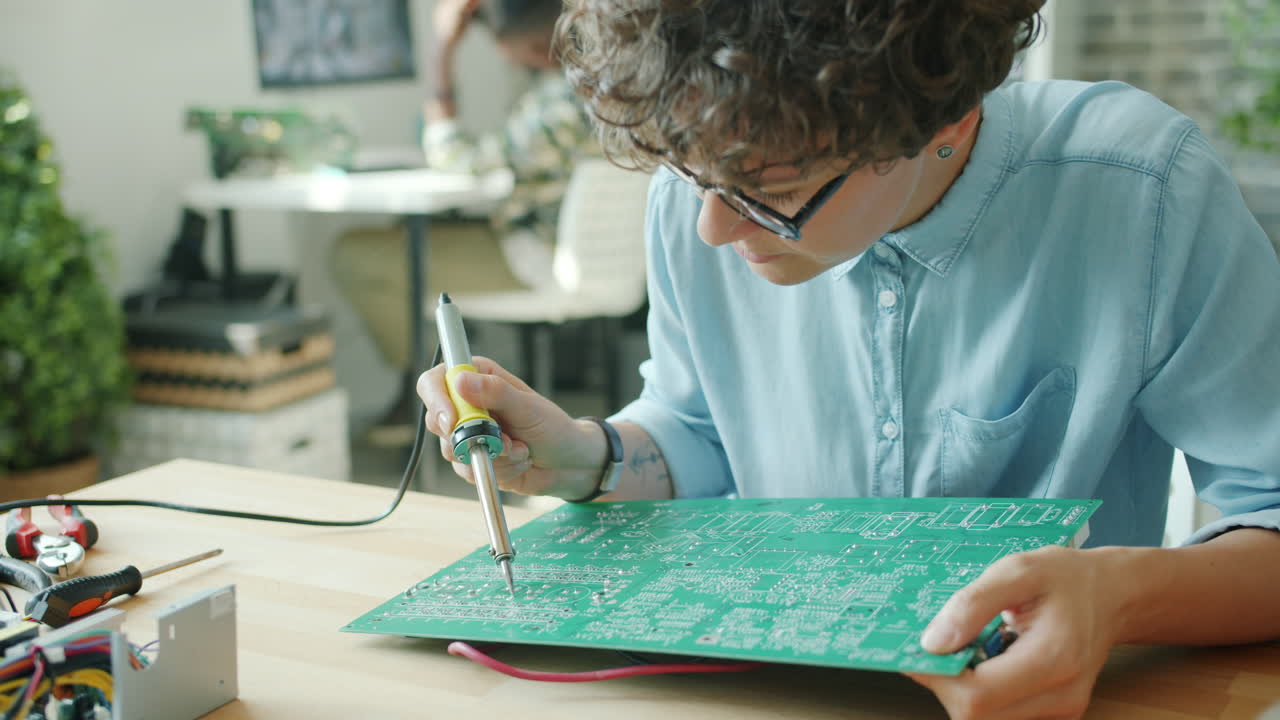 Woman repairing a circuit board