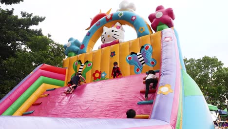 children playing on colorful inflatable slide in bangkok