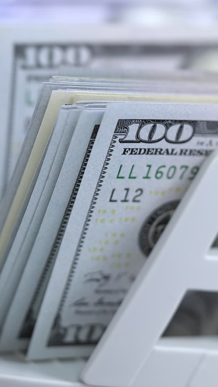 Stack of Hundred Dollar Bills in a Bill Counter