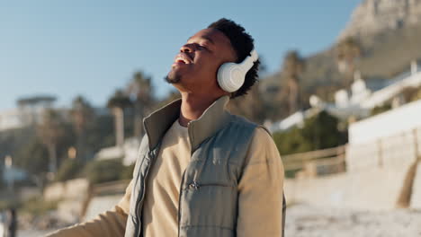 headphones, music and black man dance at beach