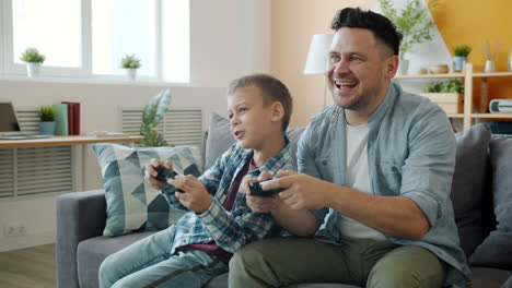 father and son playing video games together