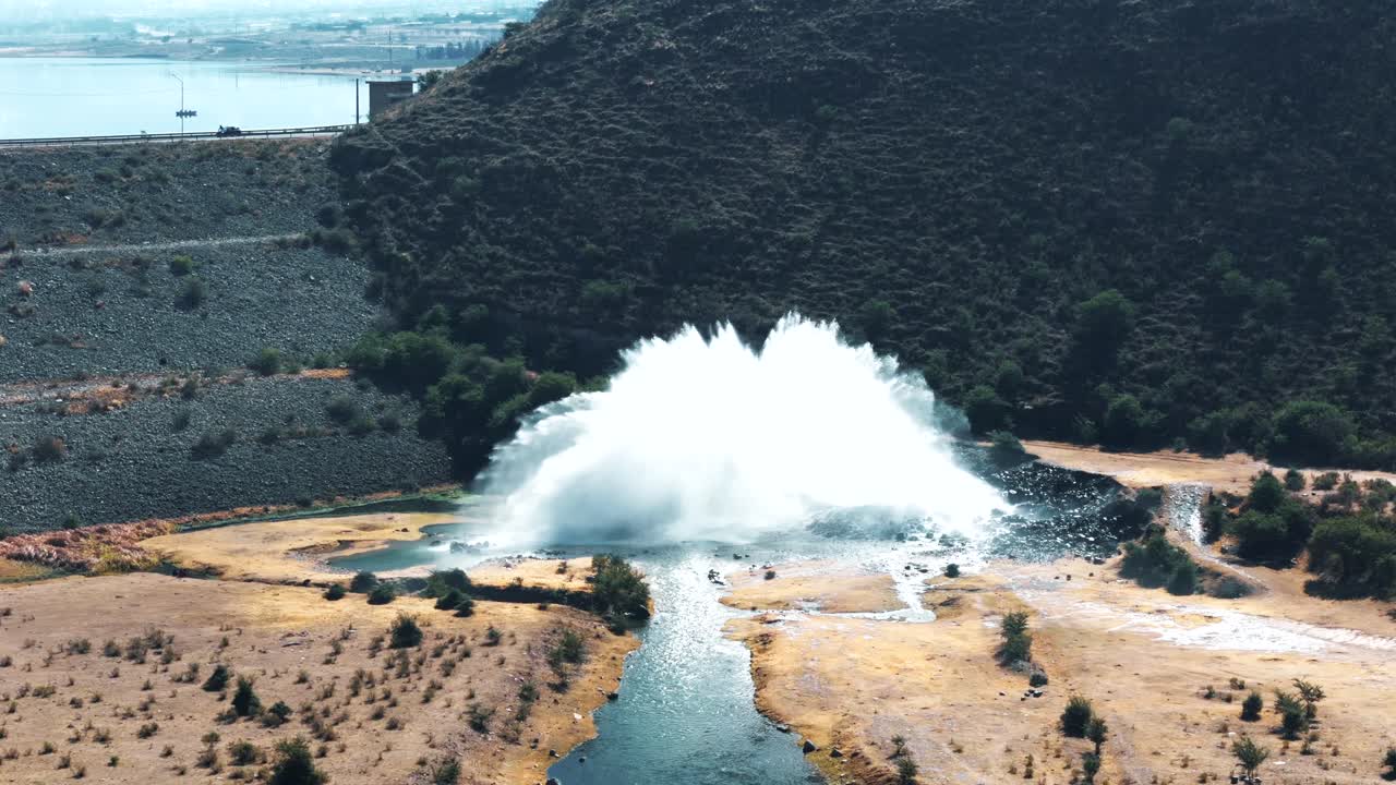Aerial image approaching a water spillway in a dam located in the Andes Mountains