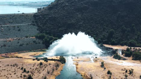 aerial image approaching a water spillway in a dam located in the andes mountains