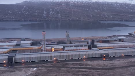 industrial aluminium factory on fjord shore in iceland, aerial