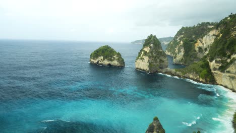 panorama shot of the beautiful cliffs in front of diamond beach on nusa penida overlooking the blue sea on a beautiful morning