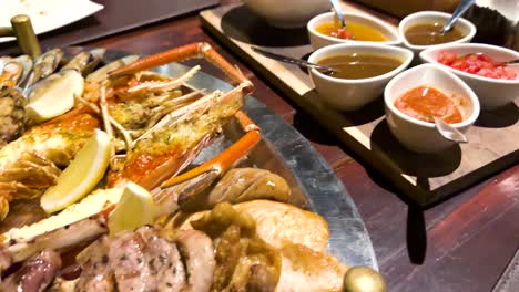 delicious seafood and meat platter with sauces