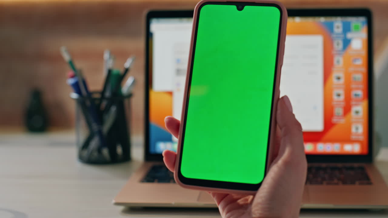 Hands swiping chromakey mobile phone shopping online at office desk close up.