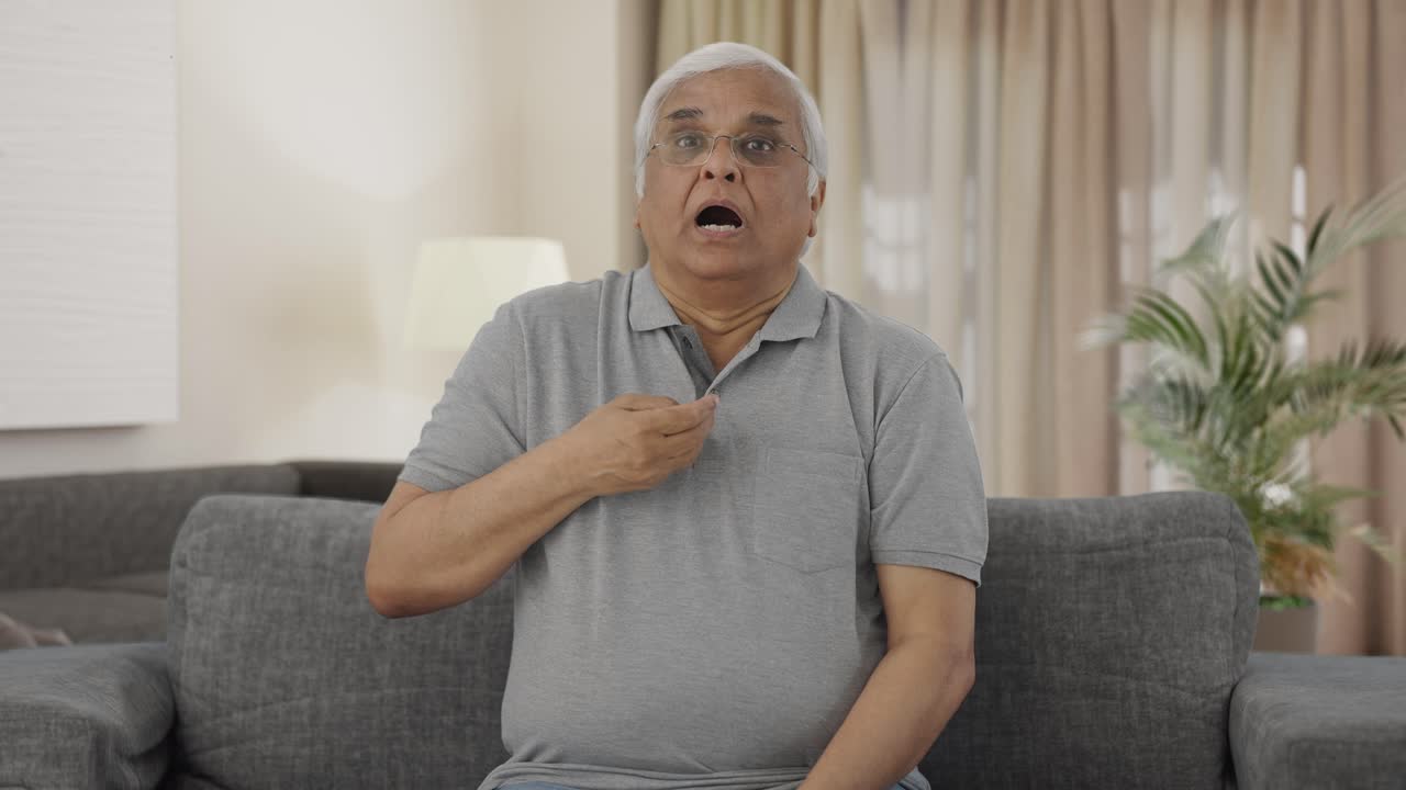 Sick Indian old man having an Asthma attack