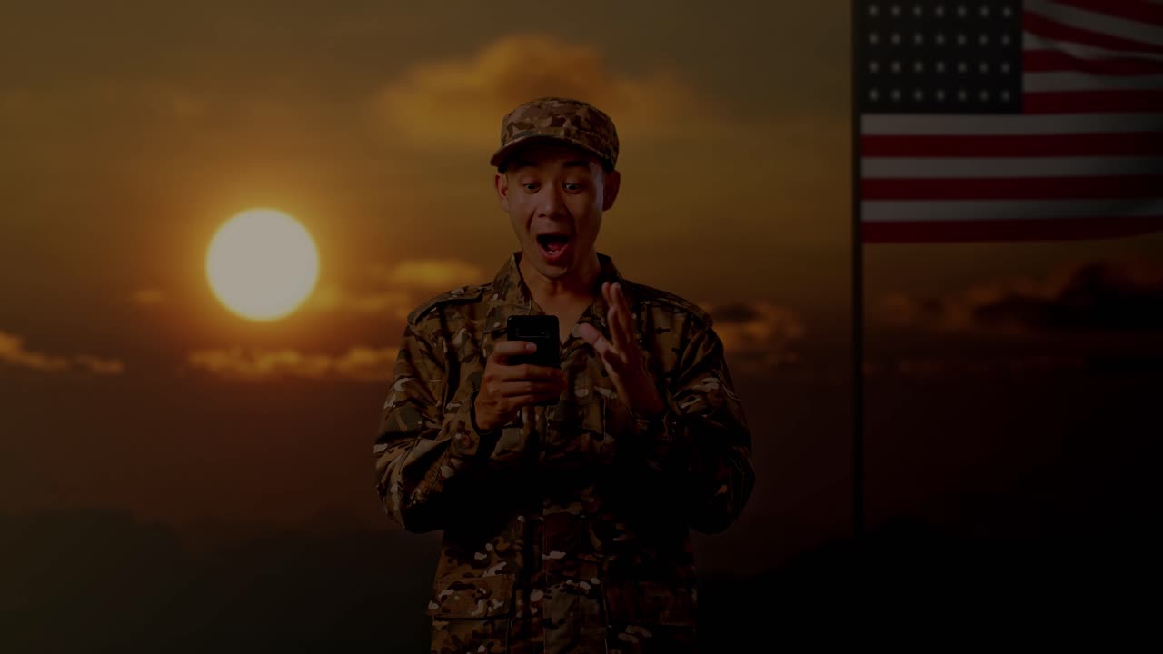 Soldato sorpreso mentre usa il telefono al tramonto