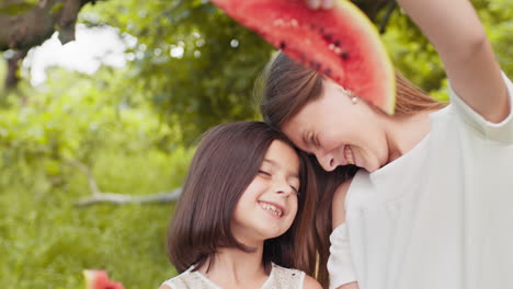 two girls enjoying a watermelon