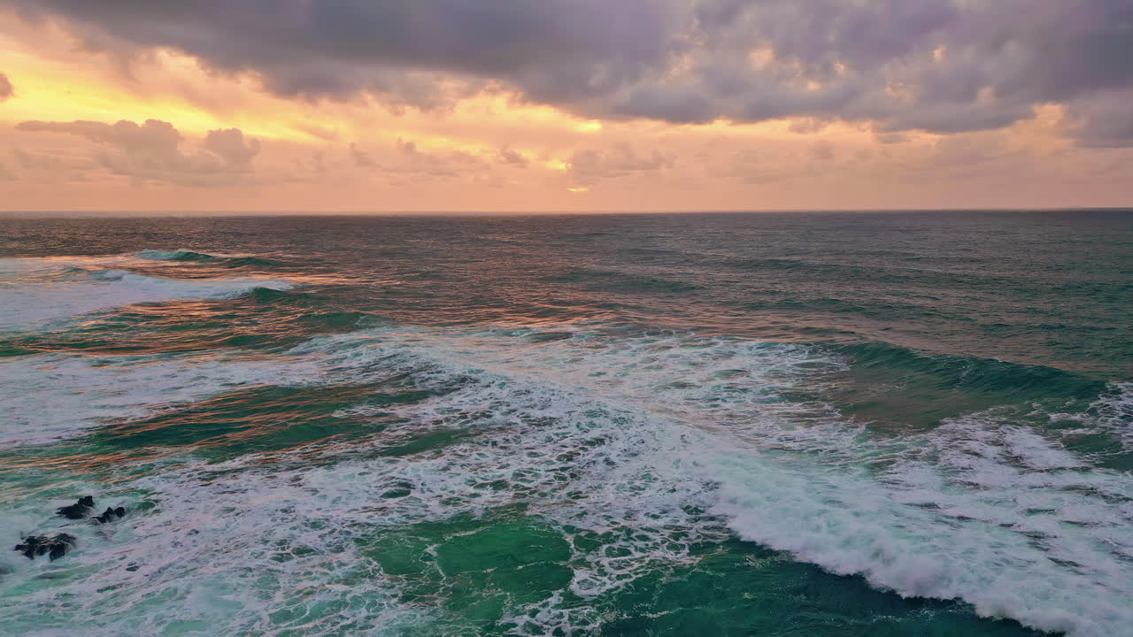 Waves flow sunset sky with golden glow. Tranquil scene ocean swell crashing