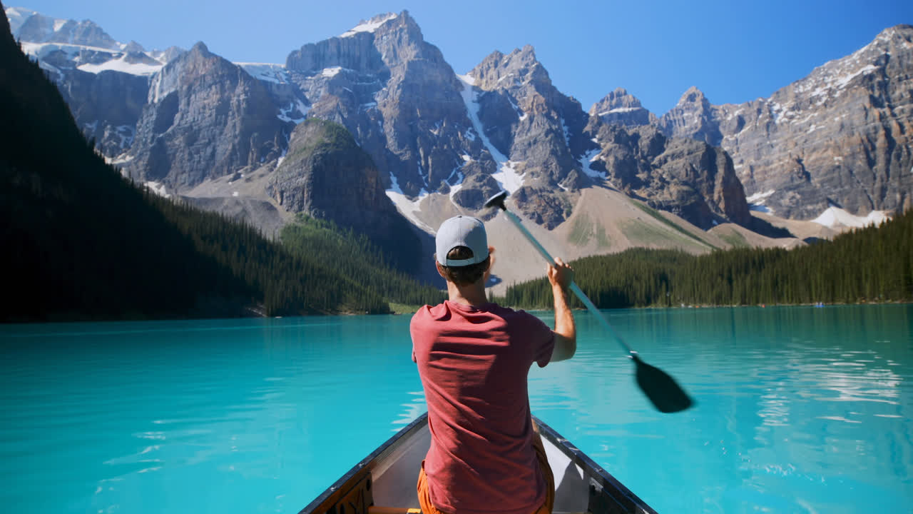Man rowing a boat in river at countryside 4k