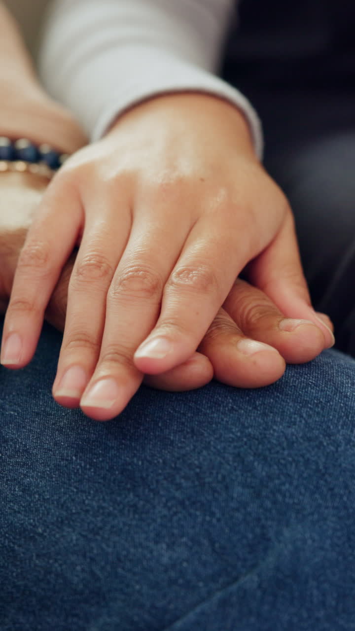 Close-up of Two Hands Gently Touching on Denim