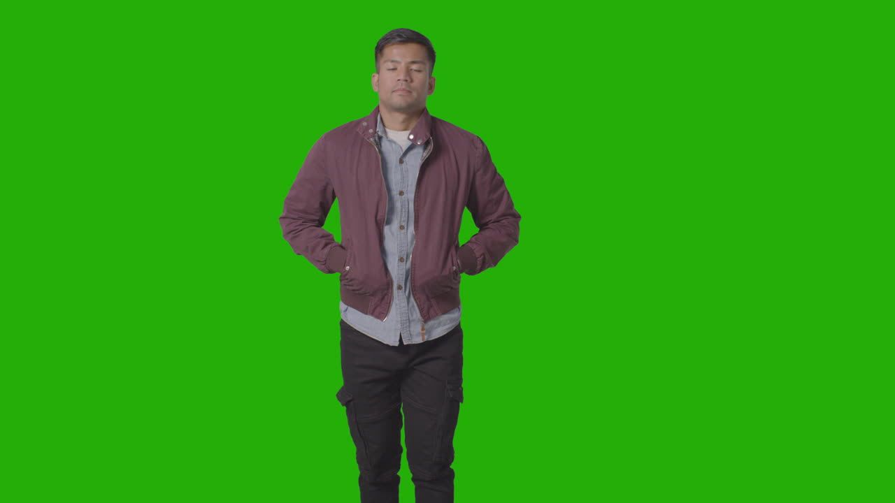 녹색 스크린을 배경으로 재킷 로켓에 손을 넣고 캐주얼하게 옷을 입은 웃고 있는 청년의 초상화