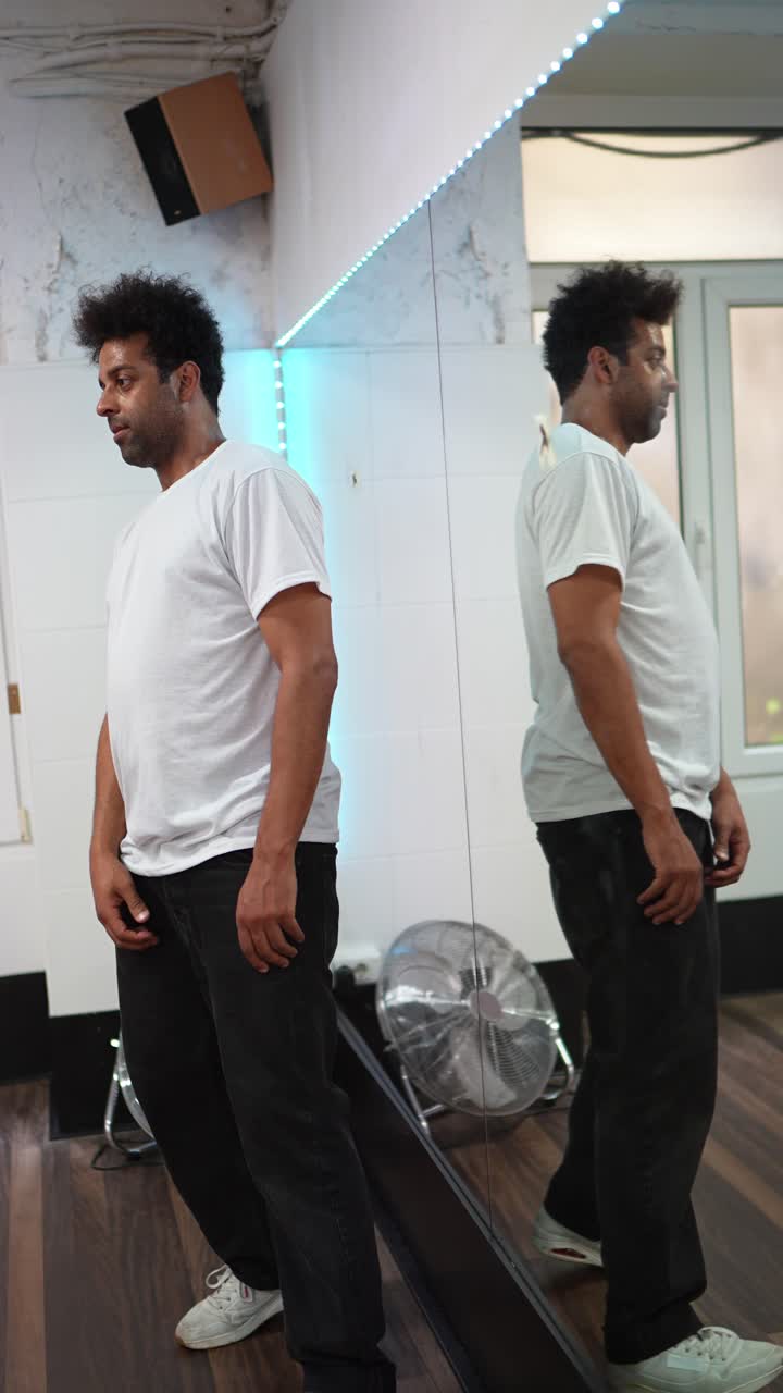 Man in Dance Studio with Mirror Reflection