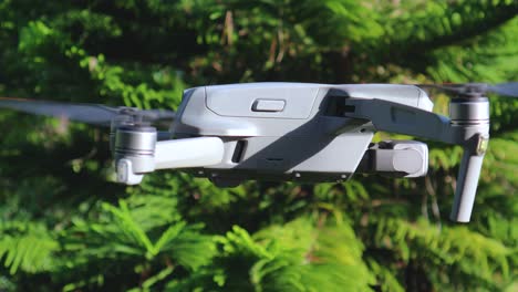 Drone-quadcopter-flying-and-turning-around,-spying,-surveillance-and-aerial-photography