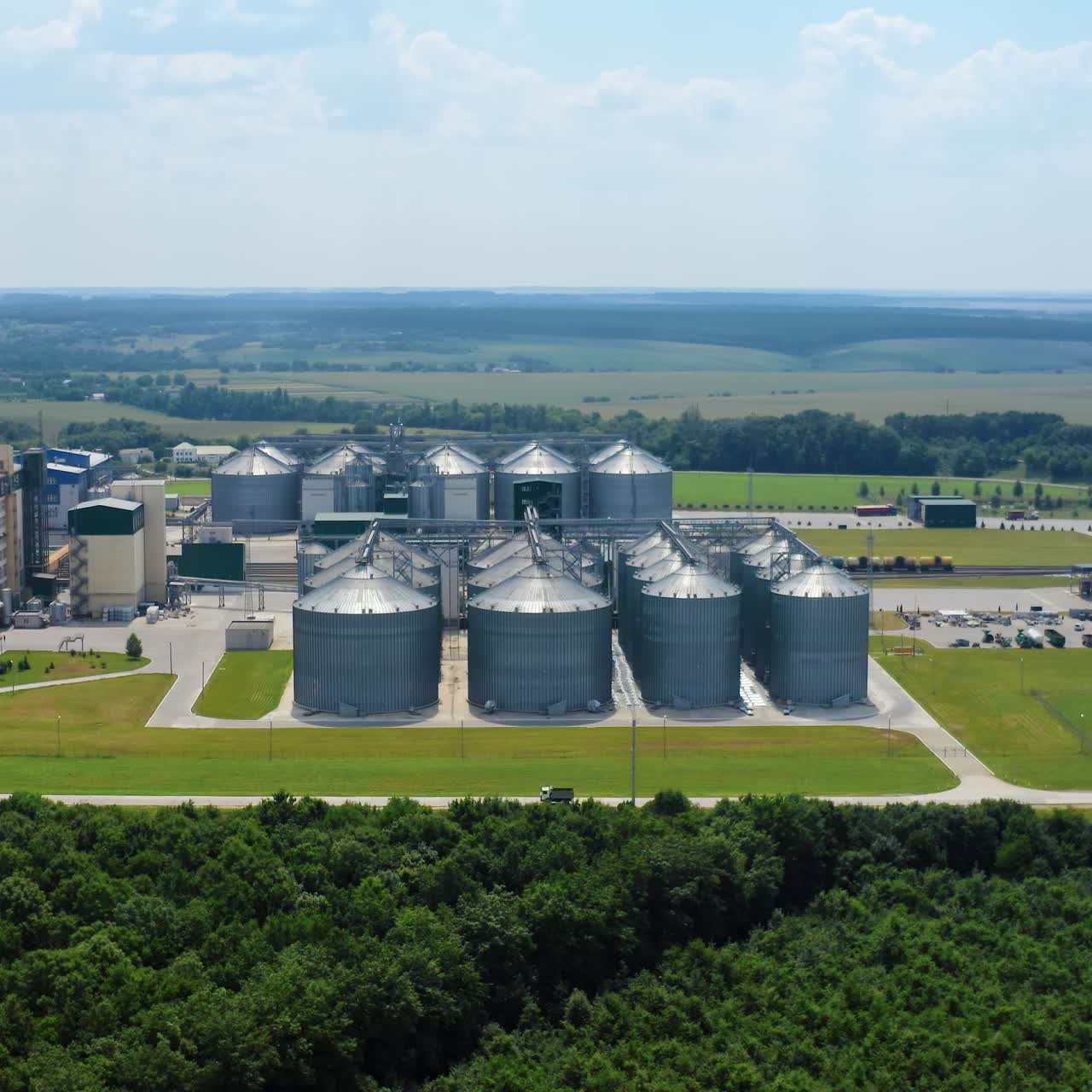 Steel silos for storing grain. Aerial view of big agricultural factory storages