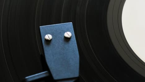 closeup of a vinyl disc spinning on a vinyl record player