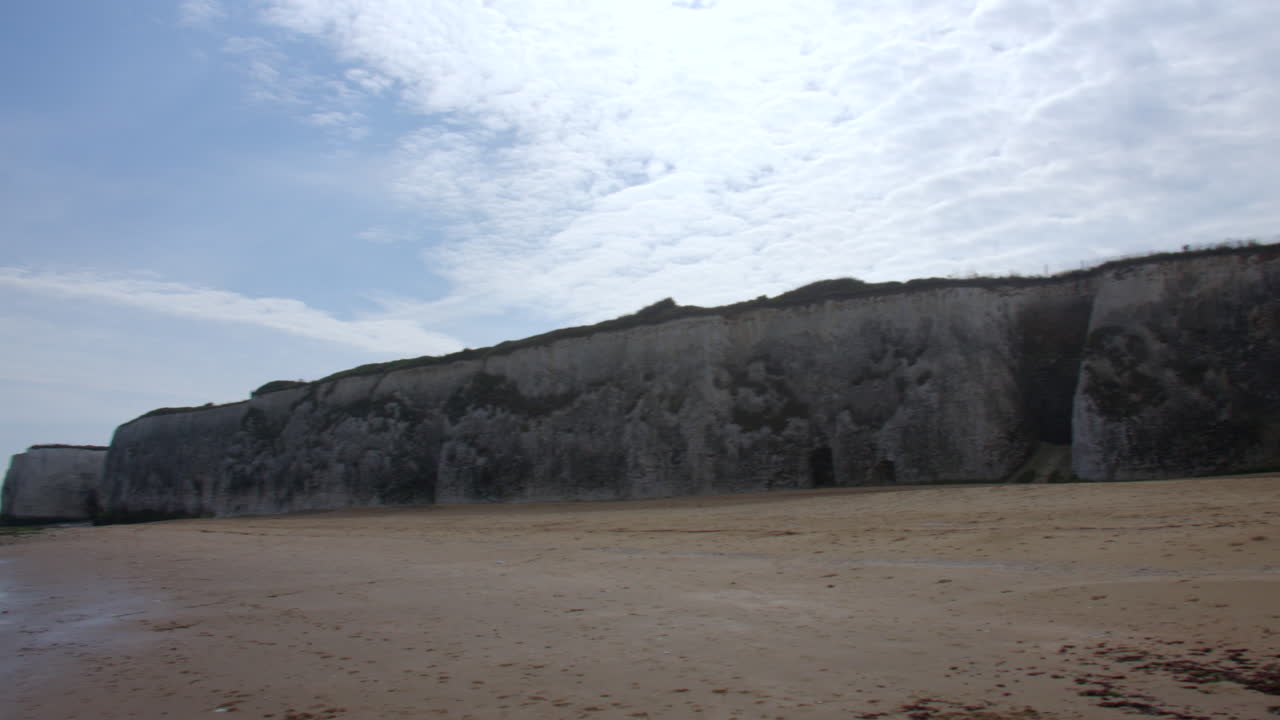 Extra wide panning shots right to left of the Chalk cliffs looking east up botany Bay Beach at low tide. At marine Drive, Broadstairs