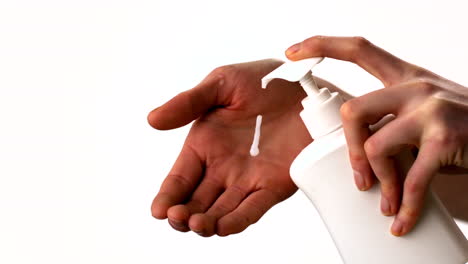 woman putting moisturiser on her hands