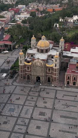 Old-church-at-the-Basilica-of-Guadalupe,-Mexico-City,-aerial-view-vertical