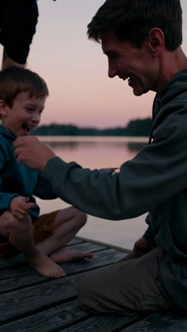 family fun on a lakeside pier at sunset