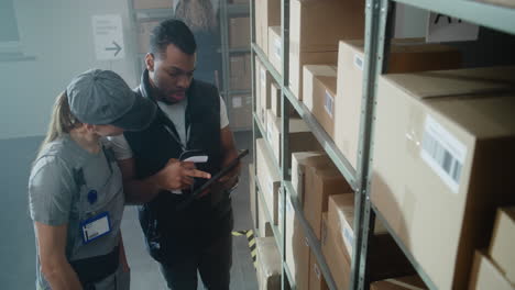 warehouse workers checking inventory with tablet