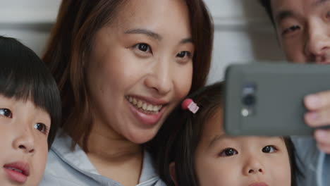 happy-asian-family-having-video-chat-using-smartphone-in-bed-mother-and-father-with-children-waving-chatting-to-friends-on-mobile-phone-enjoying-online-communication-4k-footage