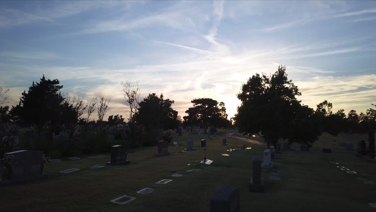 vuelo aéreo lento a través de un cementerio durante el anochecer