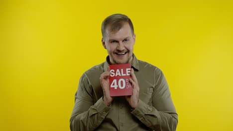 attractive man showing sale 40 percent off inscriptions signs, rejoicing good discounts, low prices