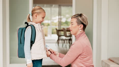 mom, kid and backpack, hugging before school