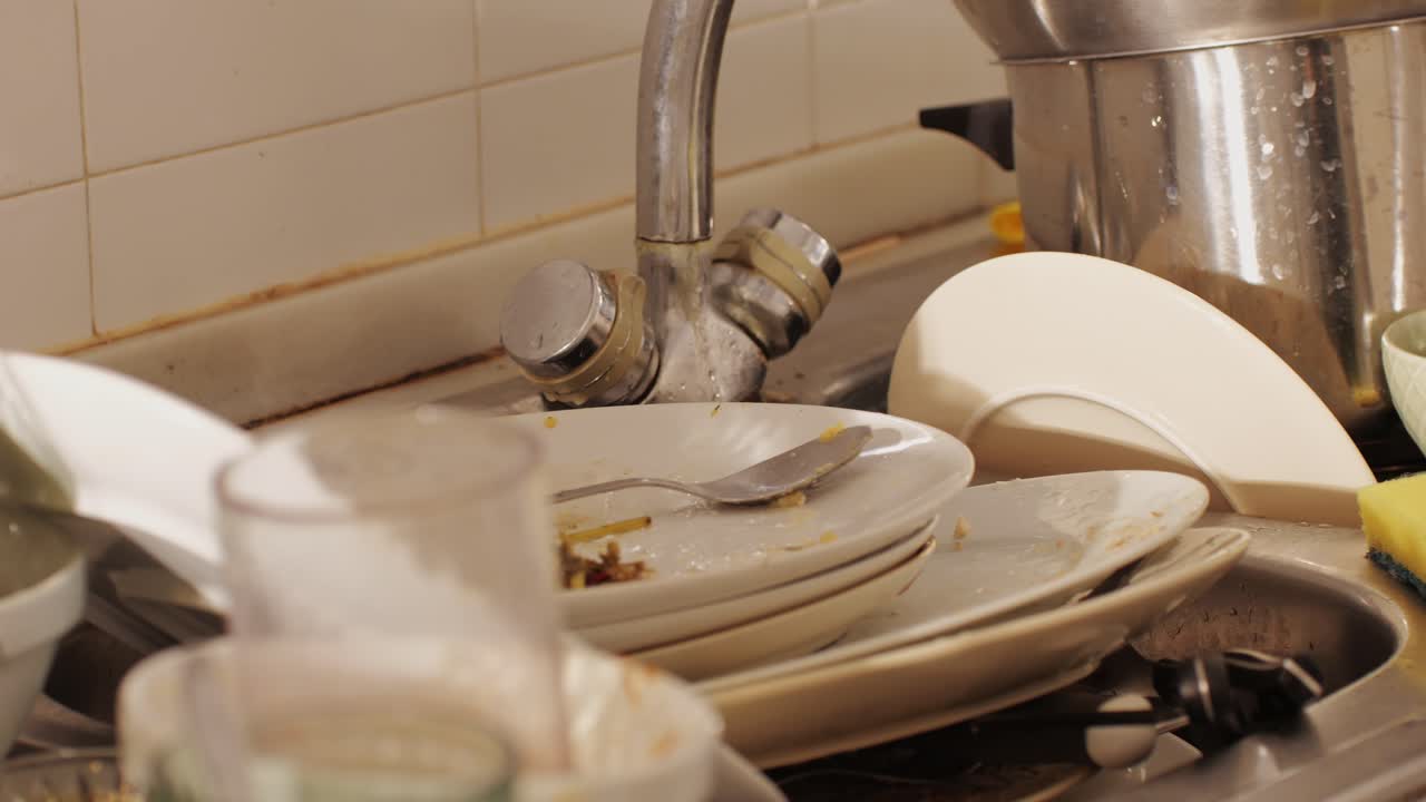 Scraps, Bones and goose or chiken skeleton on dirty dishes and mess after a party at home close-up. Christmas table after the holiday celebrating. Cleaning the house after dinner with friends and family. Home cleaning services