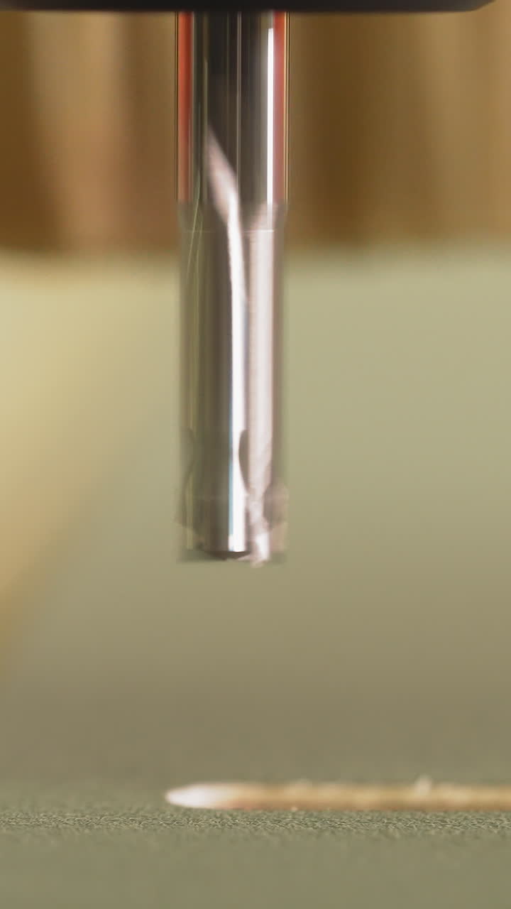 Carving geometric pattern on wooden sheet with small drill at woodwork factory macro view. Wood lathe machine processes detail creating sawdust