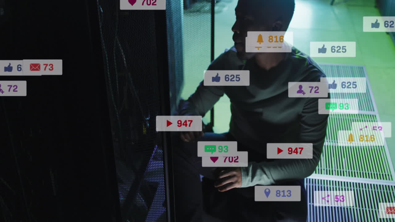 Animation of icons and numbers over african american male it technician by computer servers
