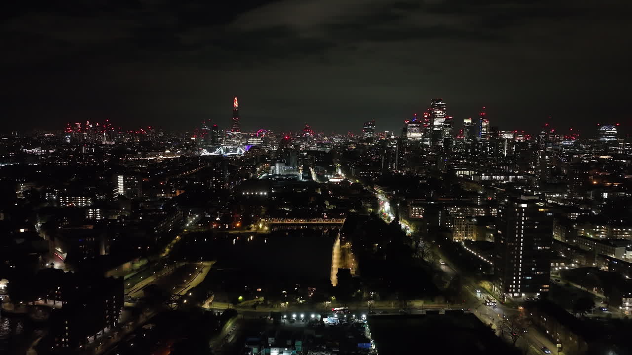 AERIAL: Shadwell, St Katharine&#x27;s and Wapping, downtown London backdrop, night