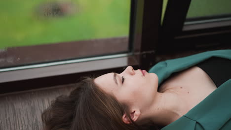 woman entrepreneur finds comfort on windowsill. rain falling outside makes tired businesswoman mind clear allowing momentarily escape worries of work