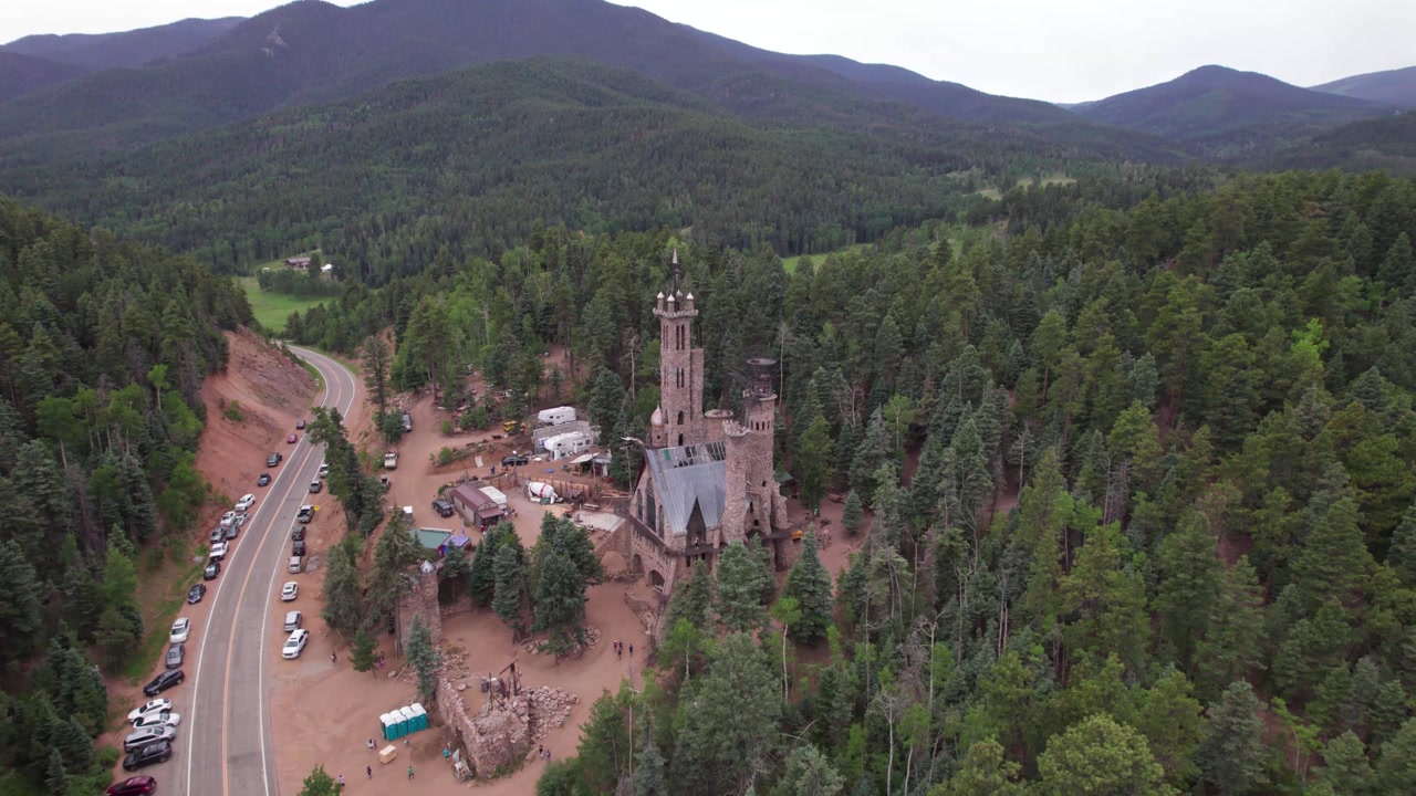 Aerial video of the Bishop Castle in Rye, Colorado. Camera rises up.