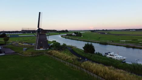 aerial shot of a dutch windmill during sunset