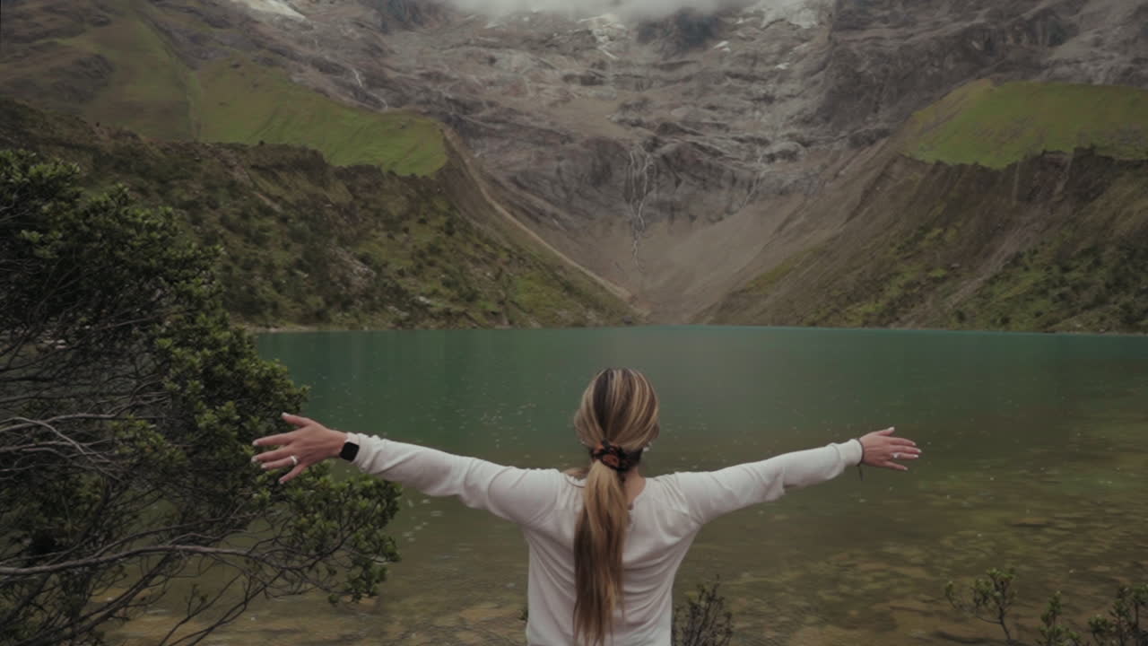 Woman enjoying the view of a lake and mountains