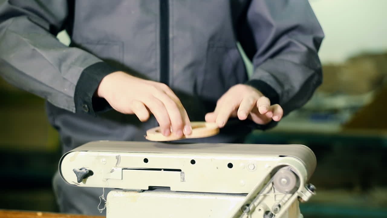 Giving Perfect Smoothness. Carpenter using electric sander. Carpenter sanding a wood with sander