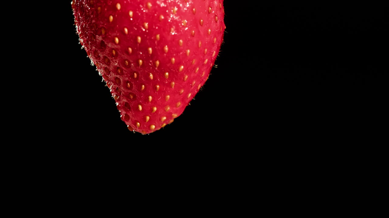 Close-up of a single strawberry with a water drop