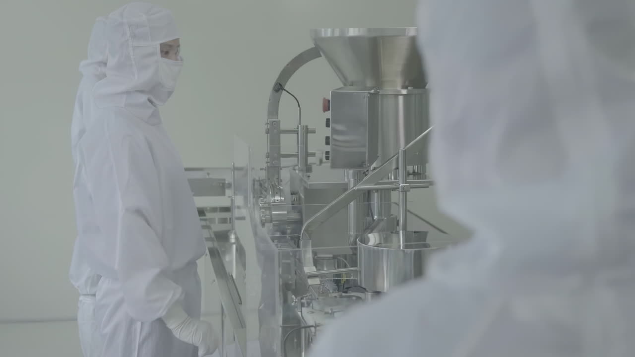Lab workers in washing gloves on pharmaceutical production line in modern factory, laboratory worker filling vials with liquid, Scientist Testing Medical Vials on Conveyor Belt