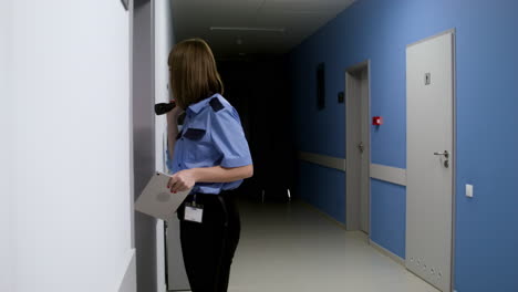 woman in uniform searching on the hallway