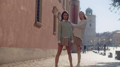 two young women posing and walking in a european city