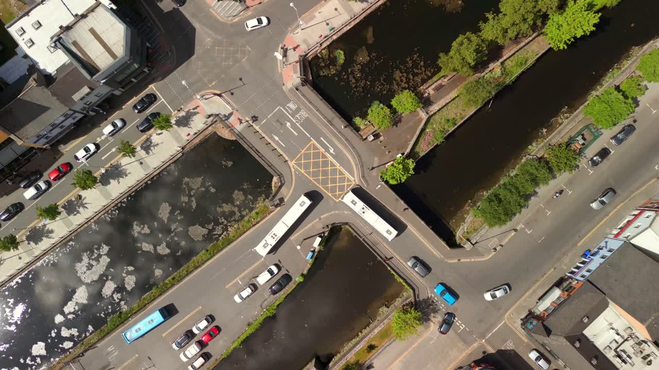 Desceding overhead aerial video of moving traffic Newry City, County Down in Northern Ireland, UK on a bright and sunny day. Filmed in 4K, 60FPS and with Rec709 color.