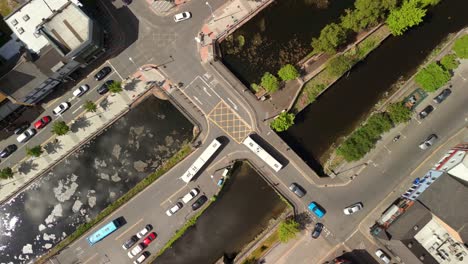 desceding overhead aerial video of moving traffic newry city, county down in northern ireland, uk on a bright and sunny day. filmed in 4k, 60fps and with rec709 color.