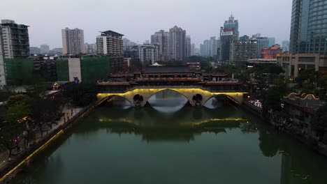 downtown city skyline and anshun bridge over jin river in chengdu, china - aerial drone view