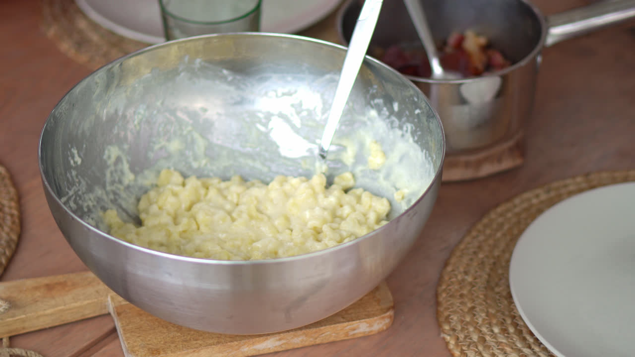 Boiled Potato Dough Lumps And Sheep Cheese Mixture In A Mixing Bowl. Bryndzove Halusky Dumplings. close up